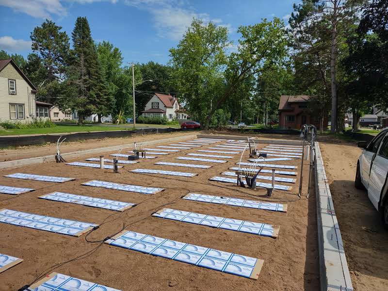 Thermal mass panels on sand inside a new foundation on a residential street
