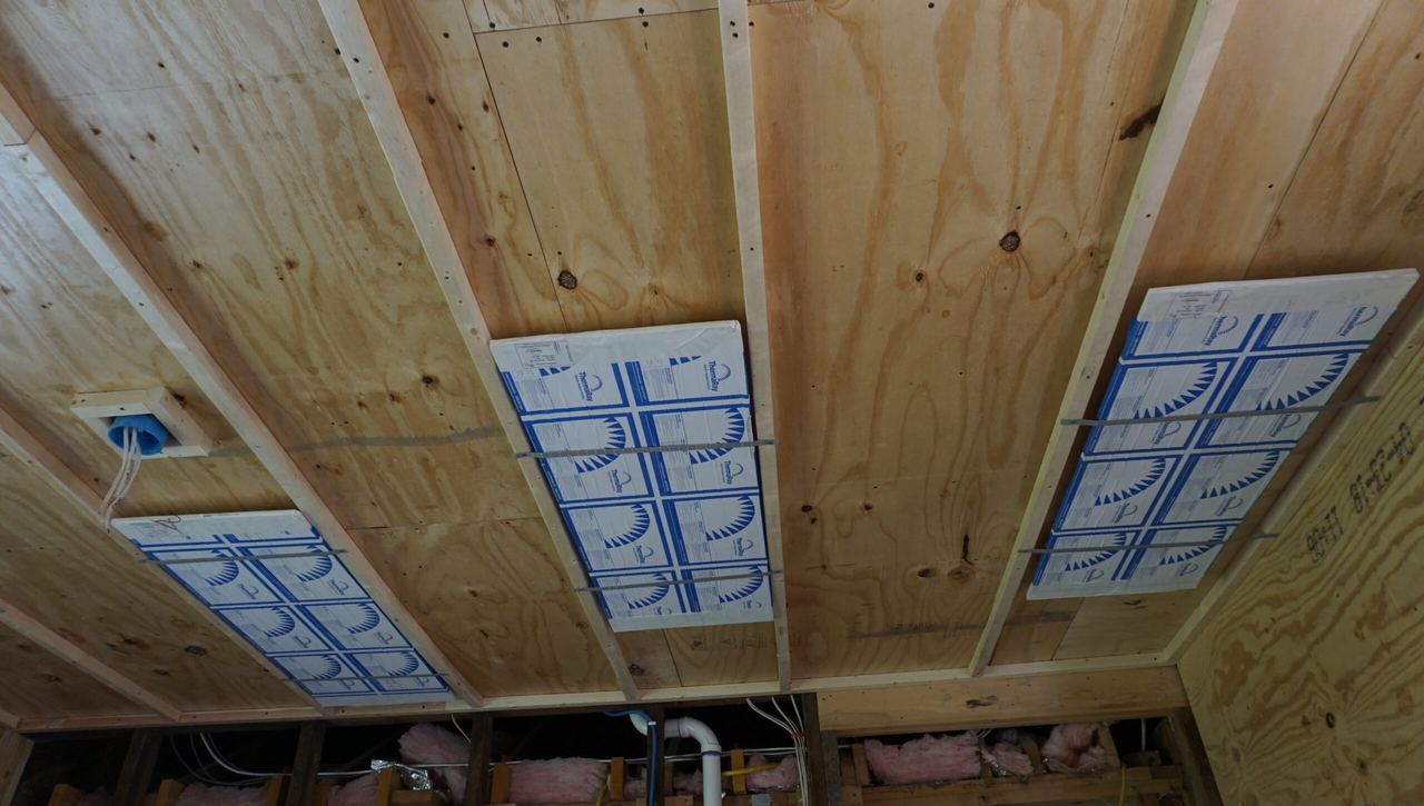 Radiant ceiling panels fastened between wood joists in the remodeled home