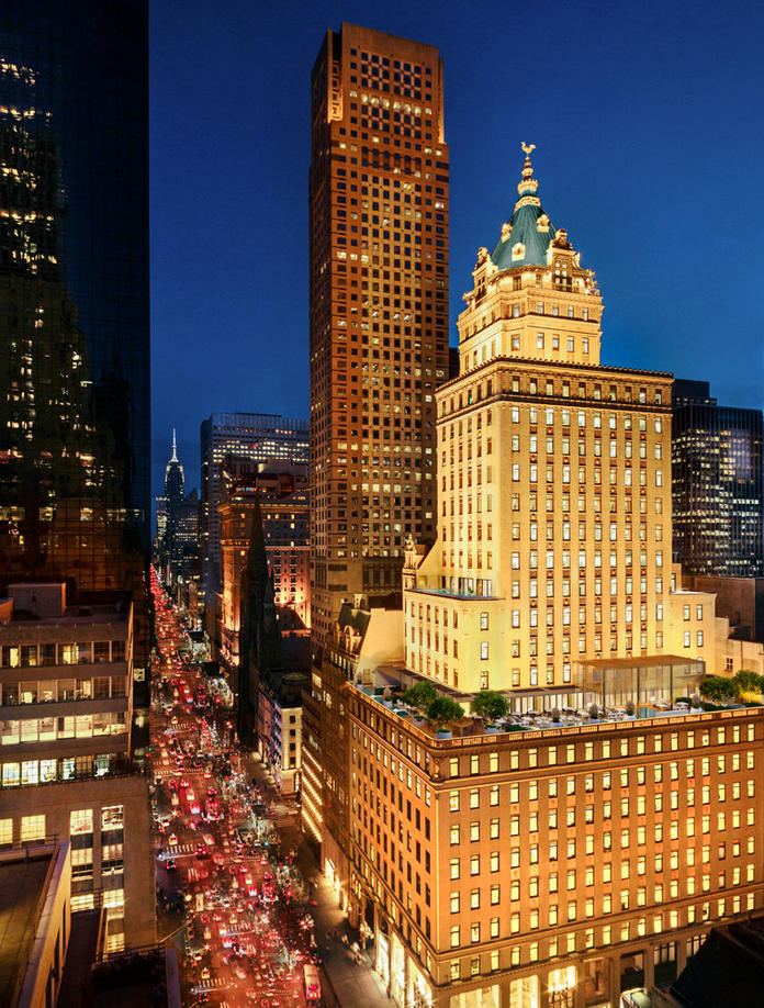 The Crown Building lit up at night on Fifth Avenue