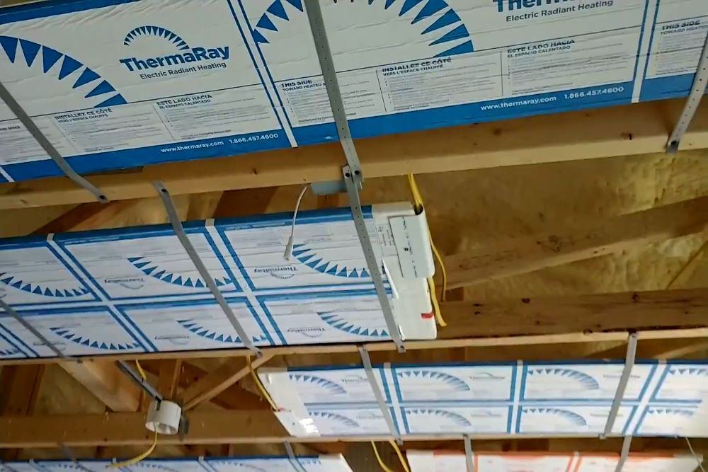 ThermaRay radiant ceiling panels installed between wood joists above the ceiling