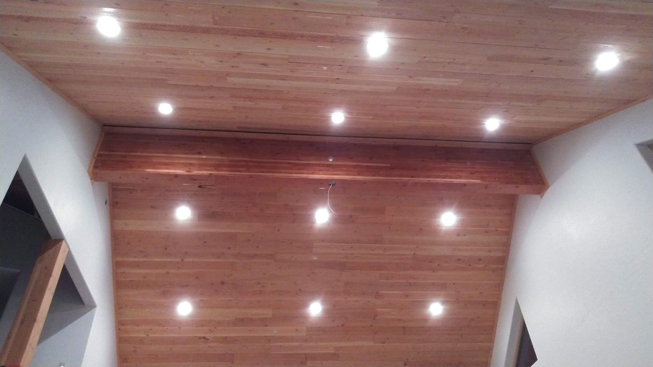 Finished tongue-and-groove wood ceiling with recessed lights