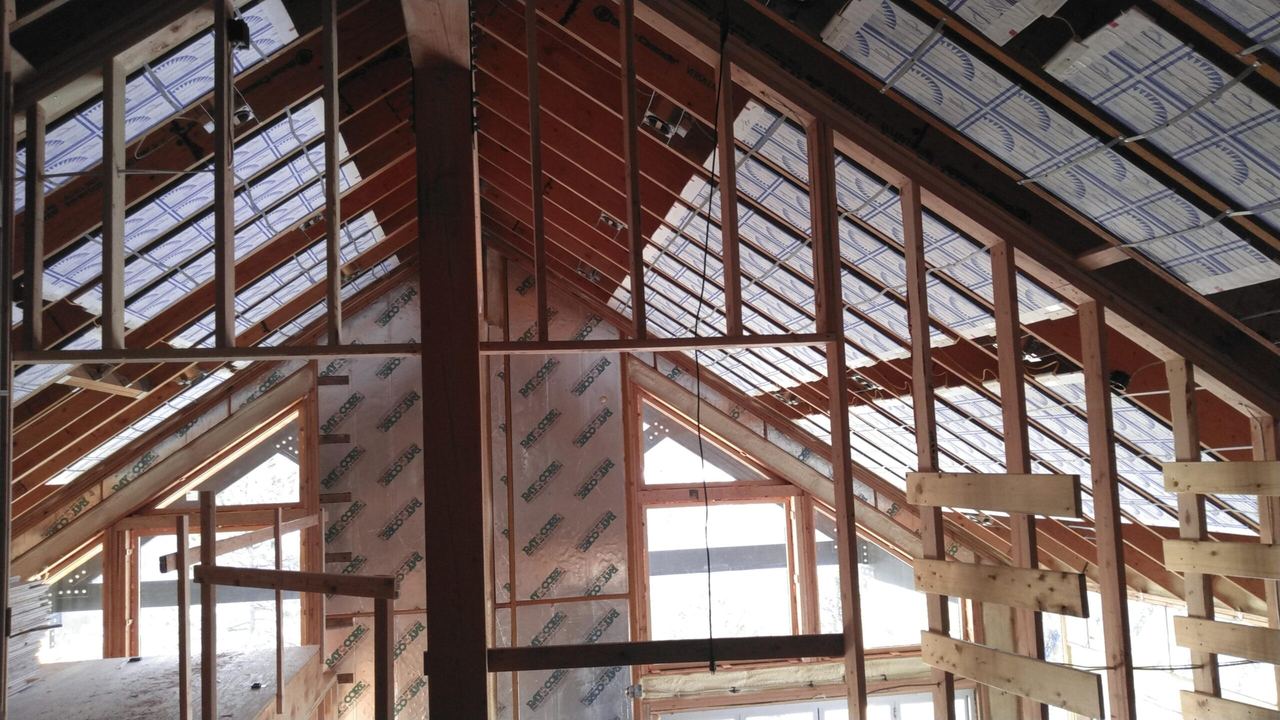 Radiant ceiling panels installed in the vaulted great room framing