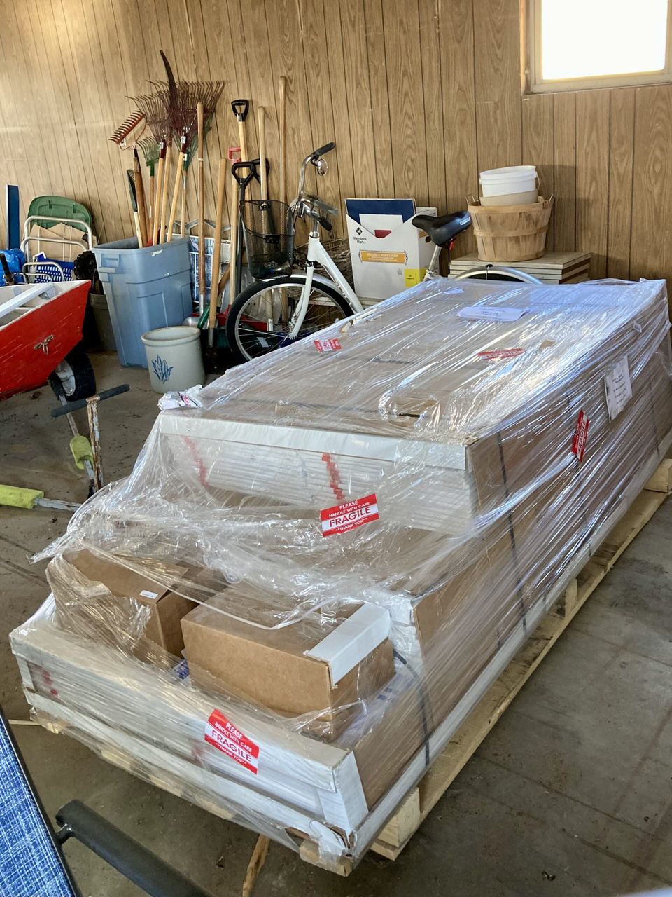 Pallet of ThermaRay heating panels and accessories in a garage