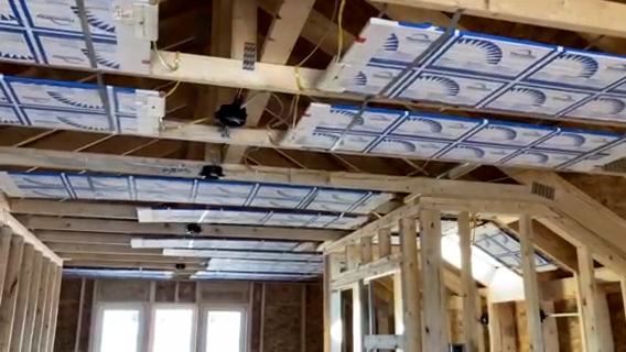 Rows of wired heating panels across the ceiling, ready for inspection