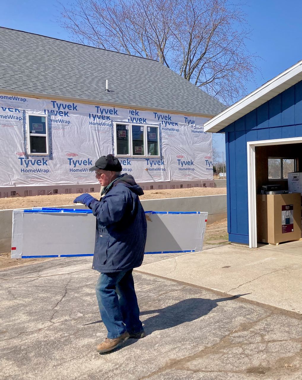 The Wisconsin home and garage in house wrap during construction