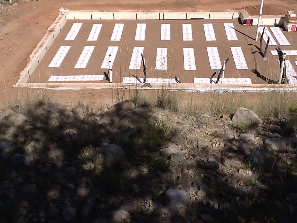Thermal mass heating panels laid out inside the home’s foundation before the slab is poured