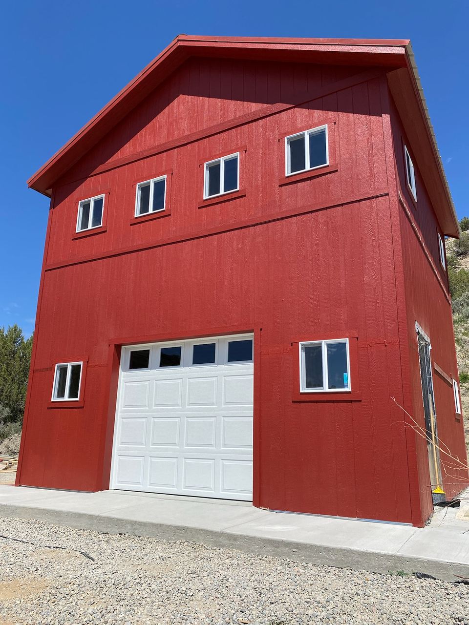 Red two-level shop and office building with a garage door