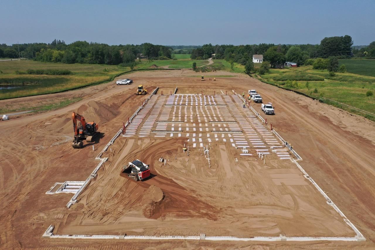 Aerial view of the building site with panels laid across the footprint
