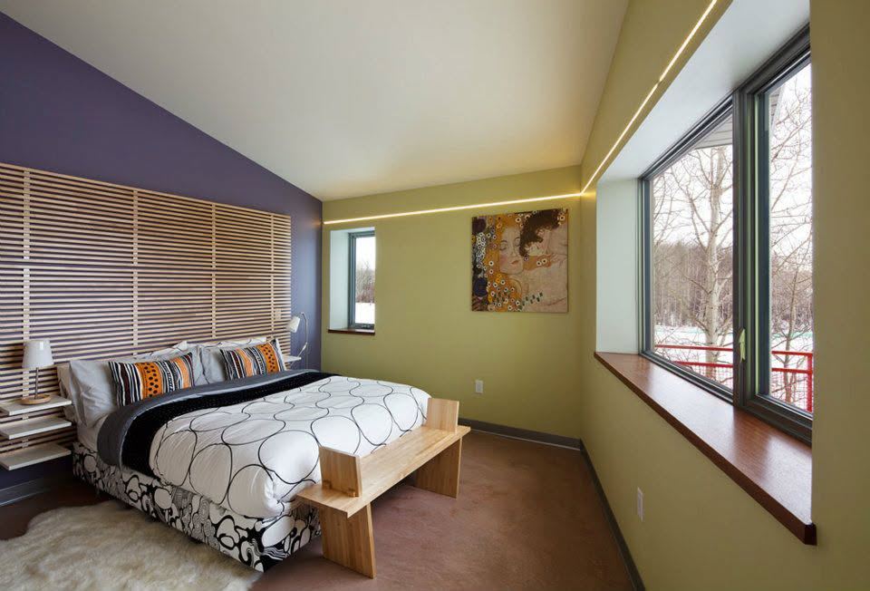 Bedroom with a corner window looking out on trees