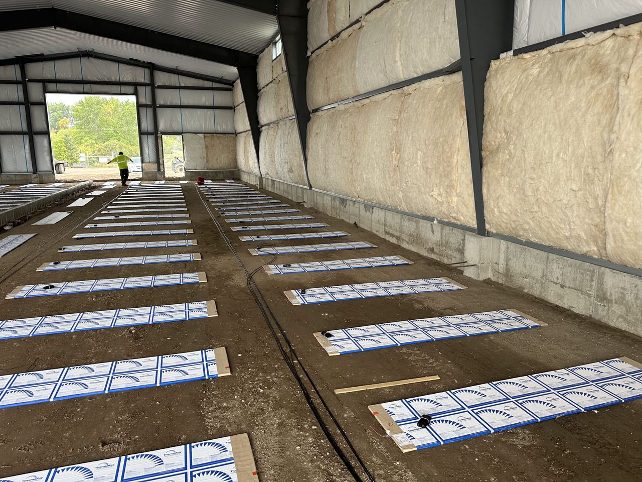 Rows of ThermaRay panels on the sand inside the Hoot Lake Solar maintenance building