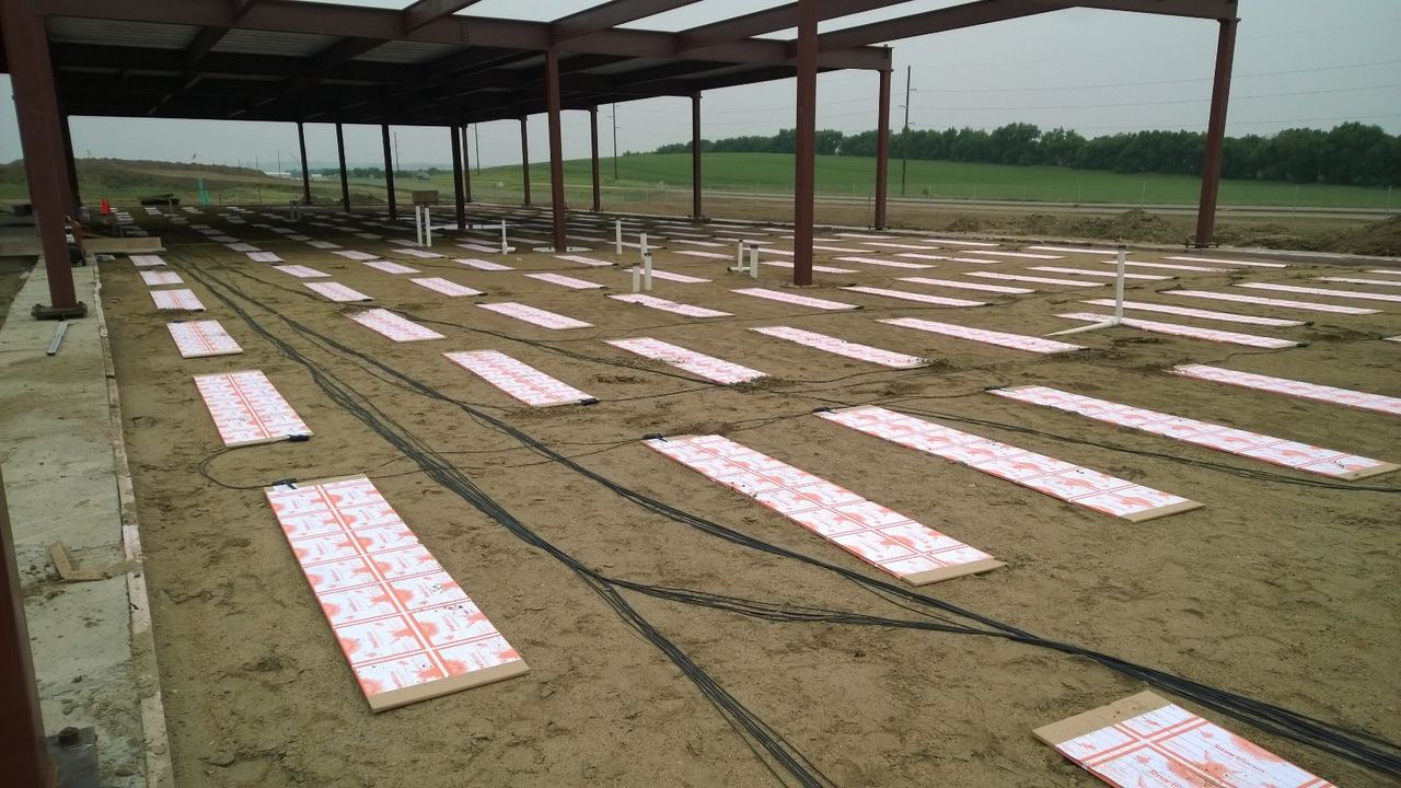 ThermaRay thermal mass panels on sand with wiring running between them at McKenzie Electric Coop