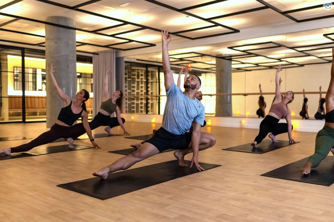 Students in a yoga class in the warm studio