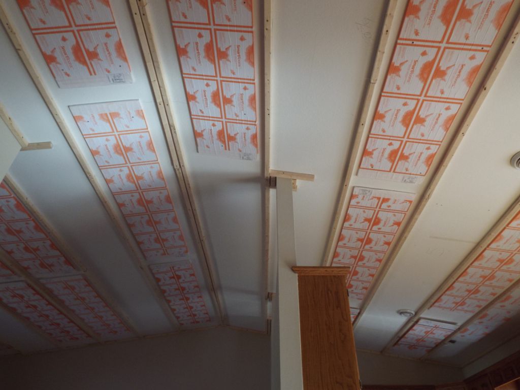 Heating panels fastened between furring strips on an existing ceiling
