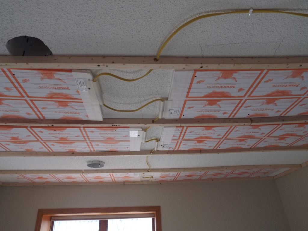 Wired heating panels on an existing ceiling before the new drywall